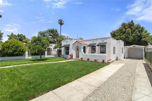 mediterranean / spanish house with a front yard