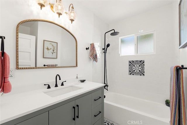 bathroom with tiled shower / bath and vanity