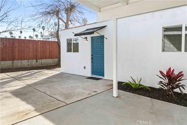 entrance to property featuring a patio area