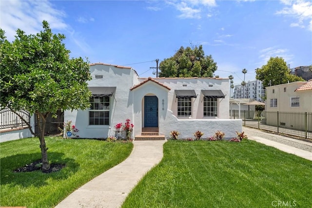 mediterranean / spanish house featuring a front lawn