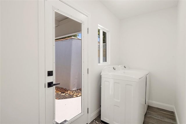 clothes washing area featuring washer and dryer and dark wood-type flooring