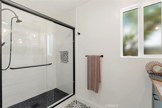 bathroom with a shower with door