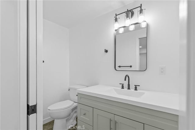 bathroom featuring vanity, toilet, and wood-type flooring