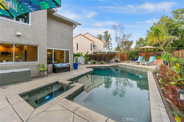 view of pool featuring an in ground hot tub and a patio