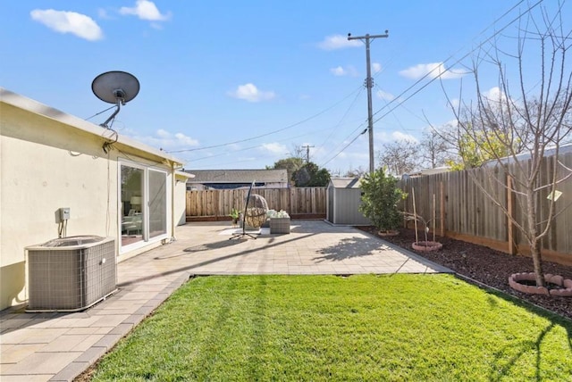 view of yard with central AC unit and a patio