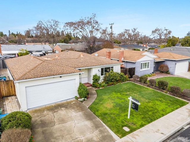 ranch-style house with a garage and a front lawn