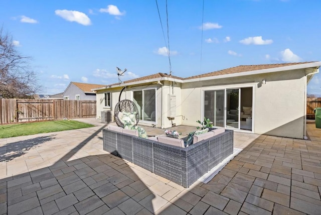 back of house with outdoor lounge area, central AC unit, and a patio