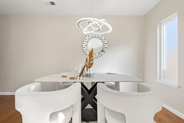 dining area with breakfast area, a healthy amount of sunlight, and wood-type flooring