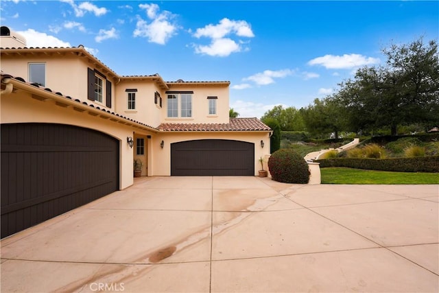 mediterranean / spanish home with a garage