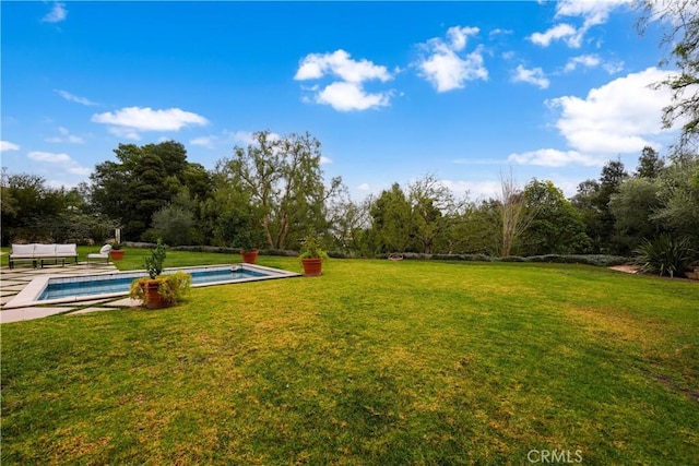 view of property's community with a yard and a swimming pool