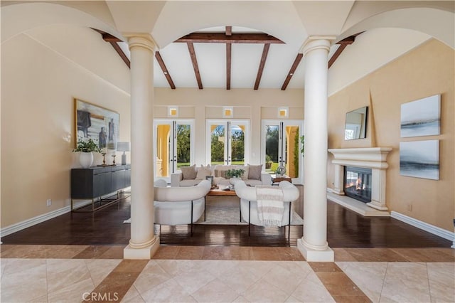 tiled living room with beamed ceiling, high vaulted ceiling, and ornate columns