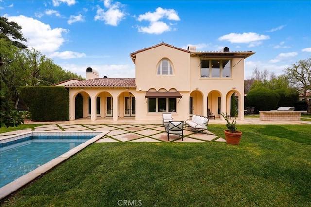 back of property featuring a patio area and a lawn