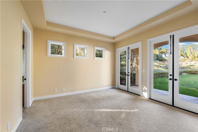 empty room featuring light carpet and french doors