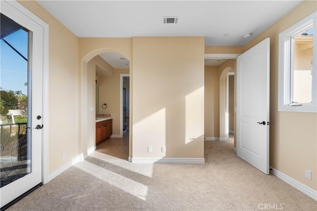 unfurnished room featuring light carpet