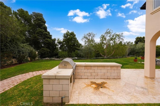 view of patio with an outdoor kitchen and area for grilling