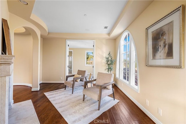 sitting room with dark hardwood / wood-style flooring