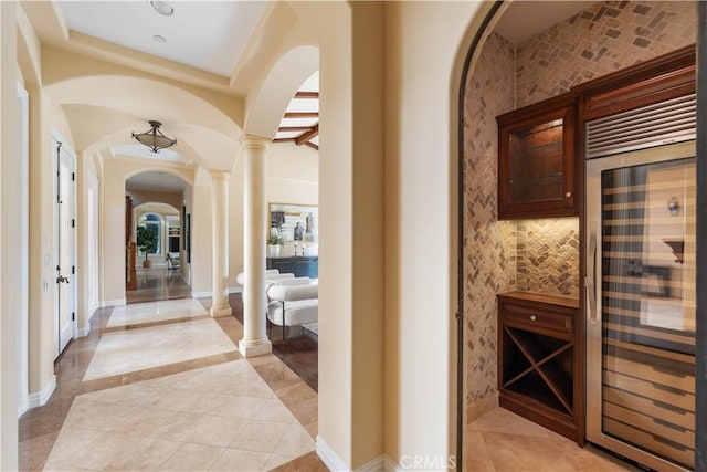 interior space featuring ornate columns and wine cooler