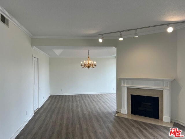 unfurnished living room featuring dark hardwood / wood-style flooring, ornamental molding, and a chandelier