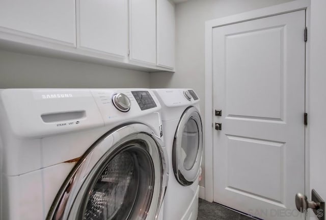 washroom with cabinets and washing machine and clothes dryer