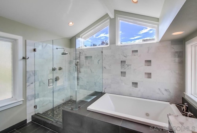 bathroom with independent shower and bath, lofted ceiling, and tile patterned flooring