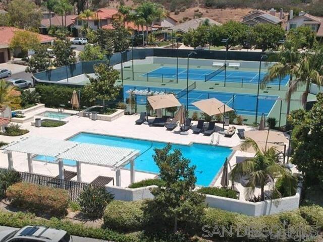 view of pool featuring tennis court