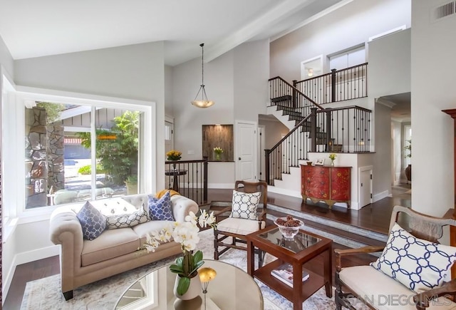 living room with dark wood-type flooring and lofted ceiling