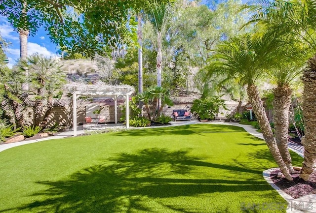 view of property's community featuring a yard and a pergola