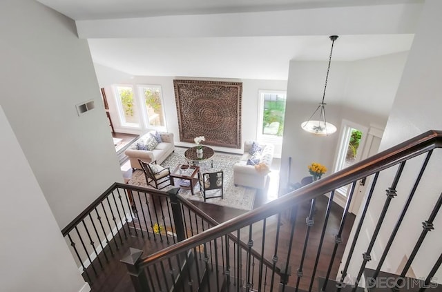 stairs featuring hardwood / wood-style floors