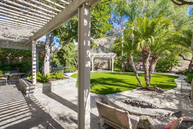 view of patio with a pergola and an outdoor fire pit