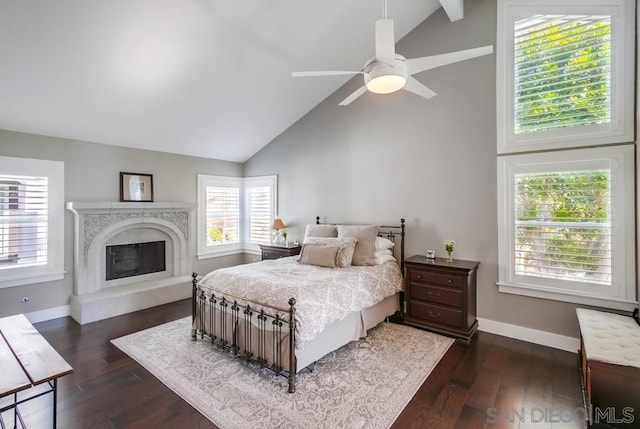 bedroom with dark hardwood / wood-style flooring, a high end fireplace, high vaulted ceiling, and ceiling fan