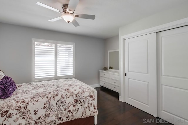 bedroom with ceiling fan, dark hardwood / wood-style flooring, and a closet