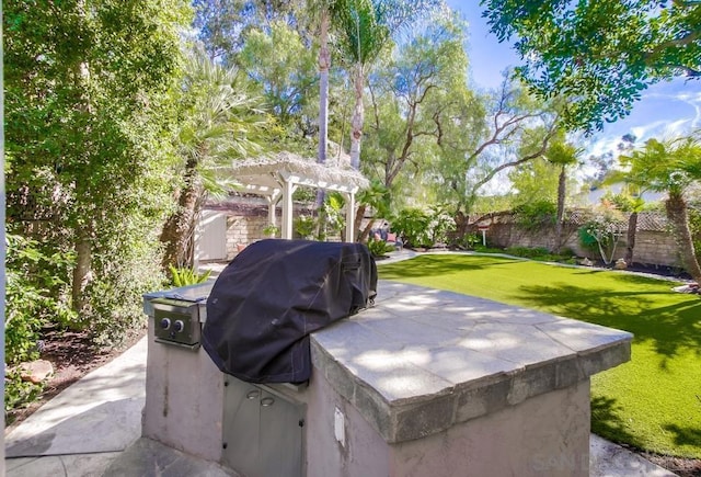 view of patio featuring a grill and a pergola