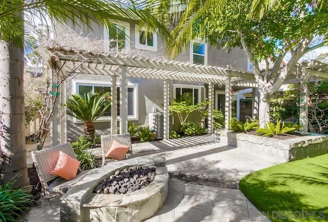 rear view of house featuring a patio, an outdoor fire pit, and a pergola