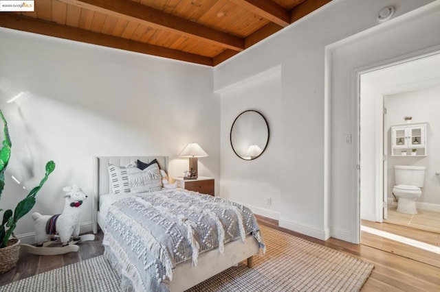 bedroom with beam ceiling, wood-type flooring, and wooden ceiling