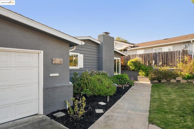 view of side of property with a garage and a yard