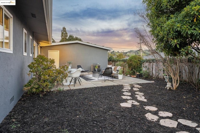 yard at dusk with a patio area