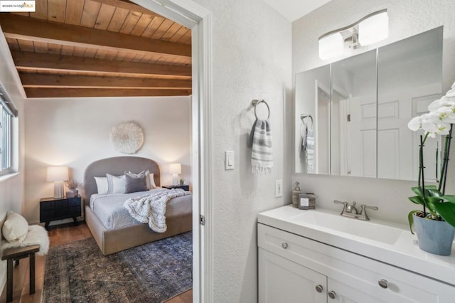 bathroom featuring beam ceiling, wood-type flooring, vanity, and wood ceiling