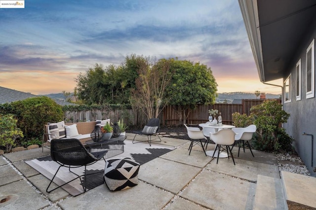 patio terrace at dusk featuring outdoor lounge area