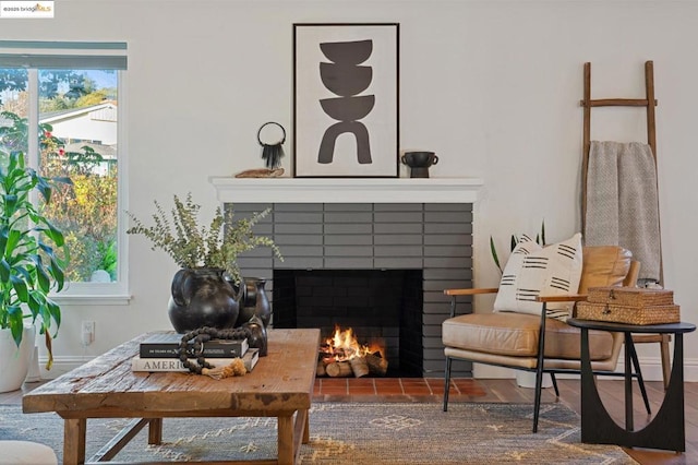 living area featuring a brick fireplace and a wealth of natural light