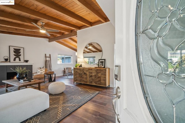 living room with dark hardwood / wood-style flooring, vaulted ceiling with beams, wood ceiling, and ceiling fan