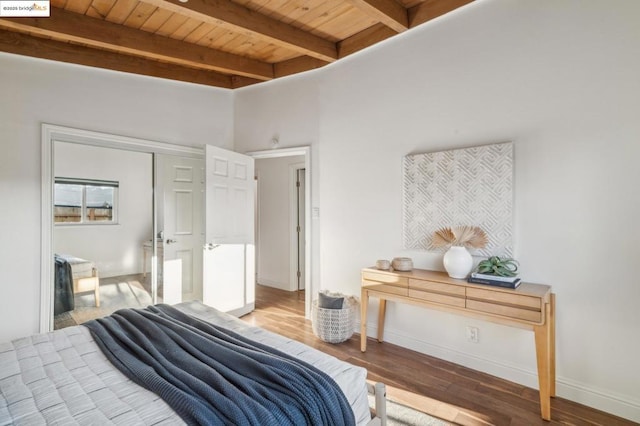 bedroom featuring wood ceiling, beam ceiling, a closet, and hardwood / wood-style flooring