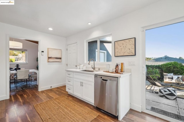 interior space featuring sink, dark wood-type flooring, white cabinets, and dishwasher