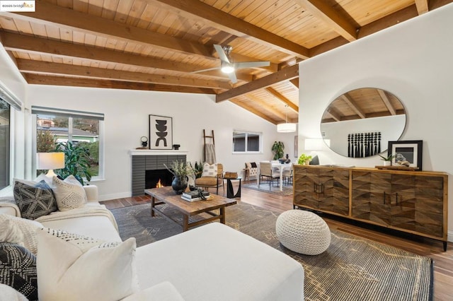 living room featuring wood ceiling, hardwood / wood-style flooring, ceiling fan, vaulted ceiling with beams, and a brick fireplace