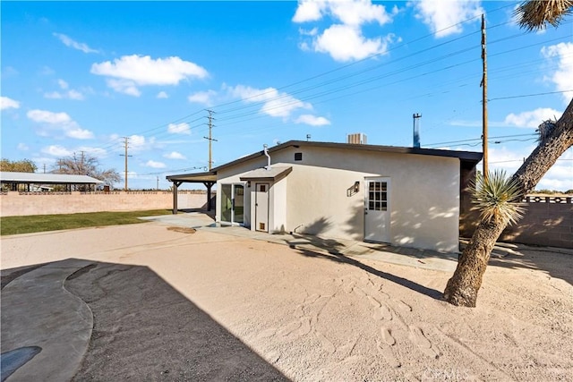 rear view of property with central AC