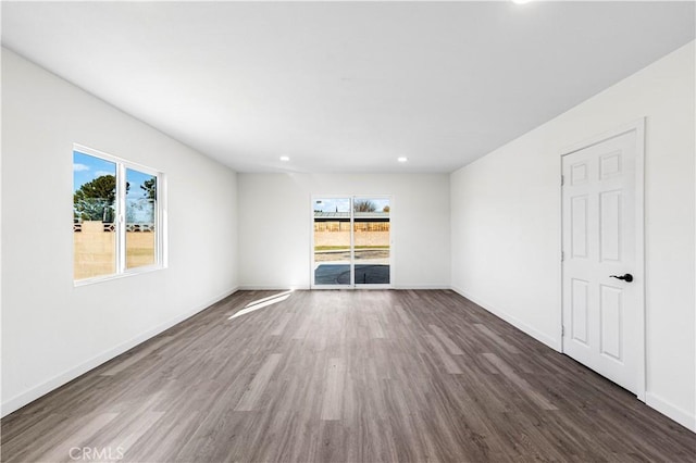 unfurnished room with dark hardwood / wood-style floors