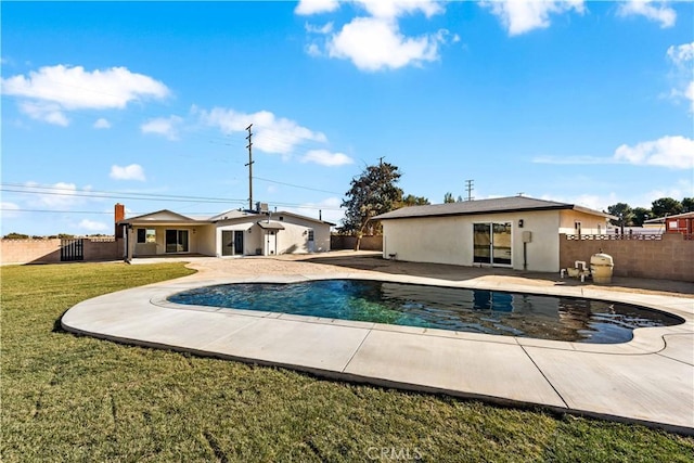 view of pool with a patio and a yard