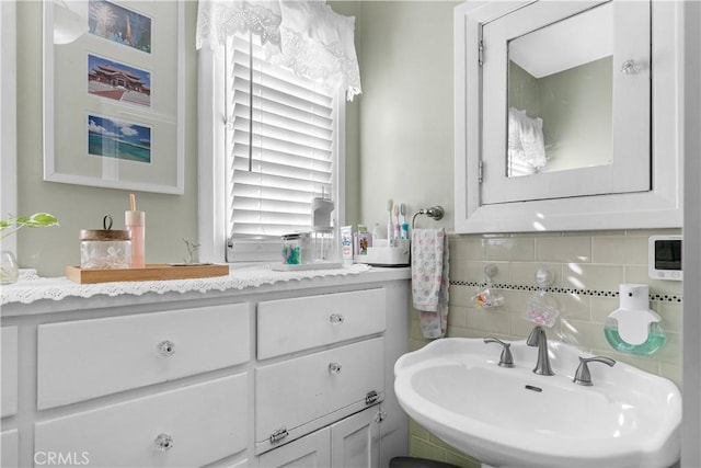 bathroom featuring tasteful backsplash and sink