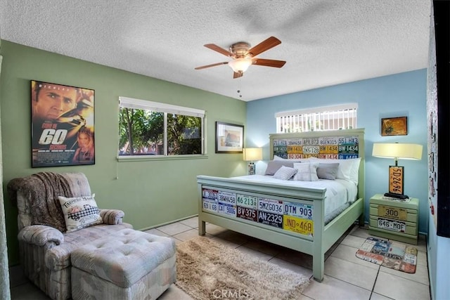 bedroom with light tile patterned flooring, multiple windows, and a textured ceiling