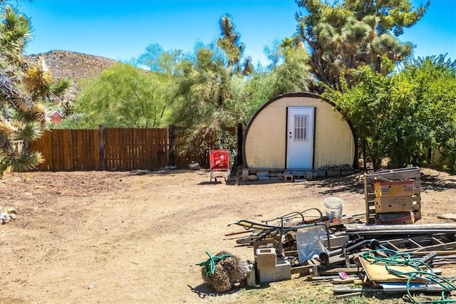 view of yard with a mountain view and a shed