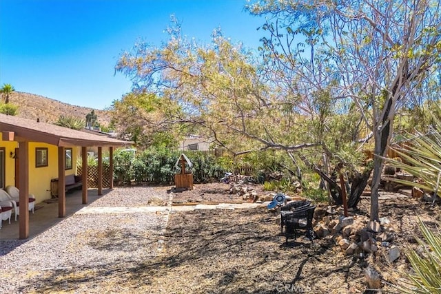 view of yard with a mountain view and a patio area